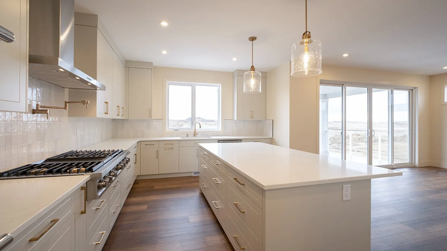 Open plan kitchen with dining area in the background