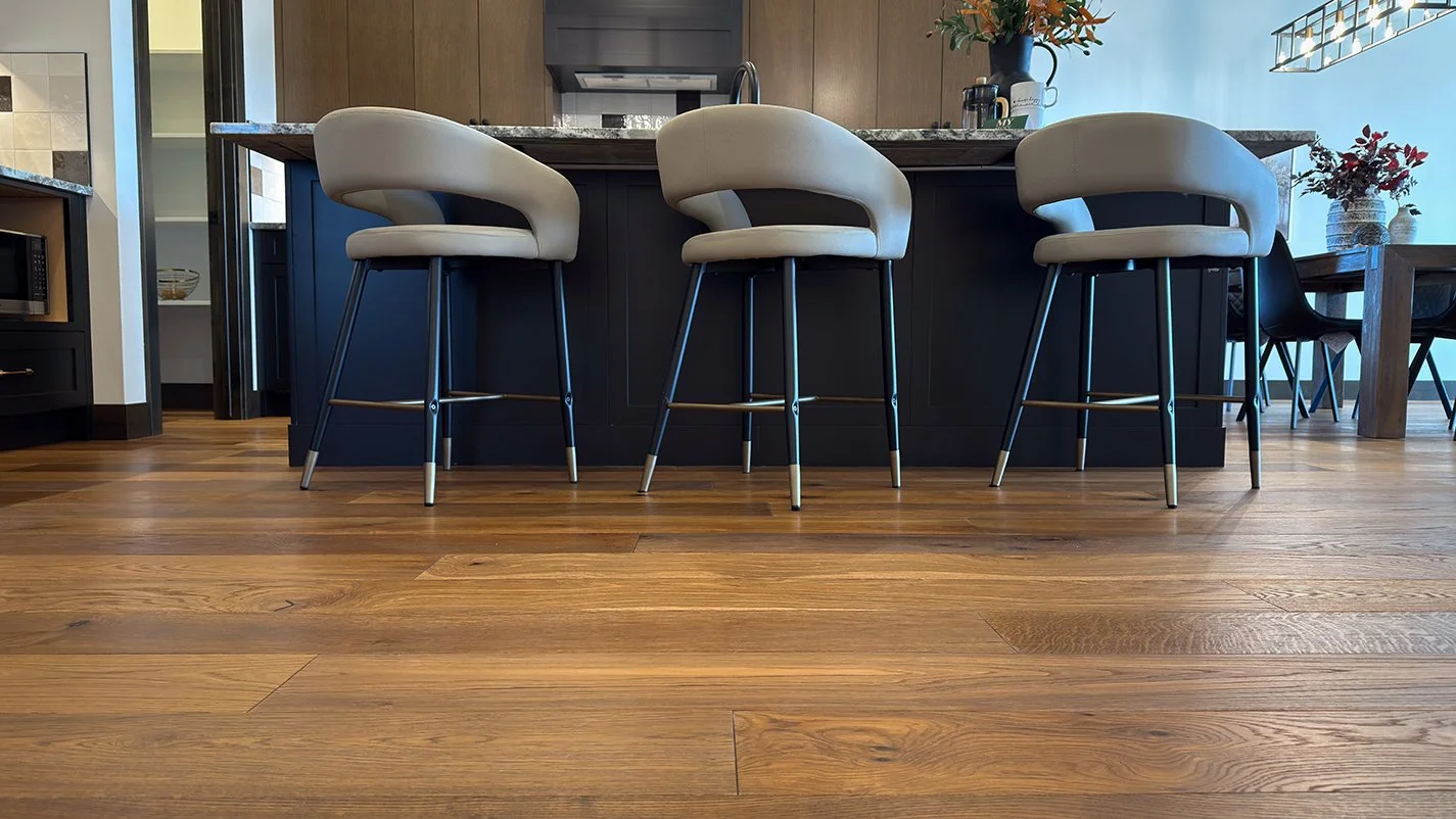 Photo of bar stools lines up against a granite kitchen counter