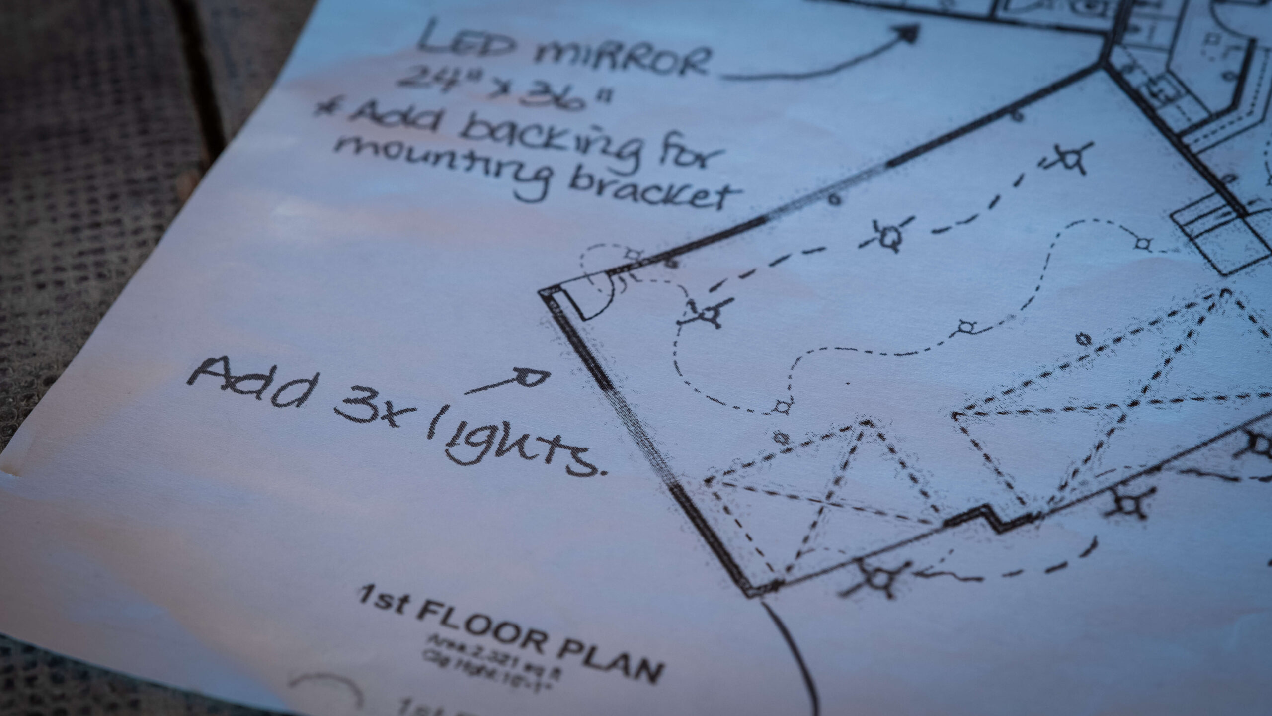 Close up of a home floor plan on a desk top